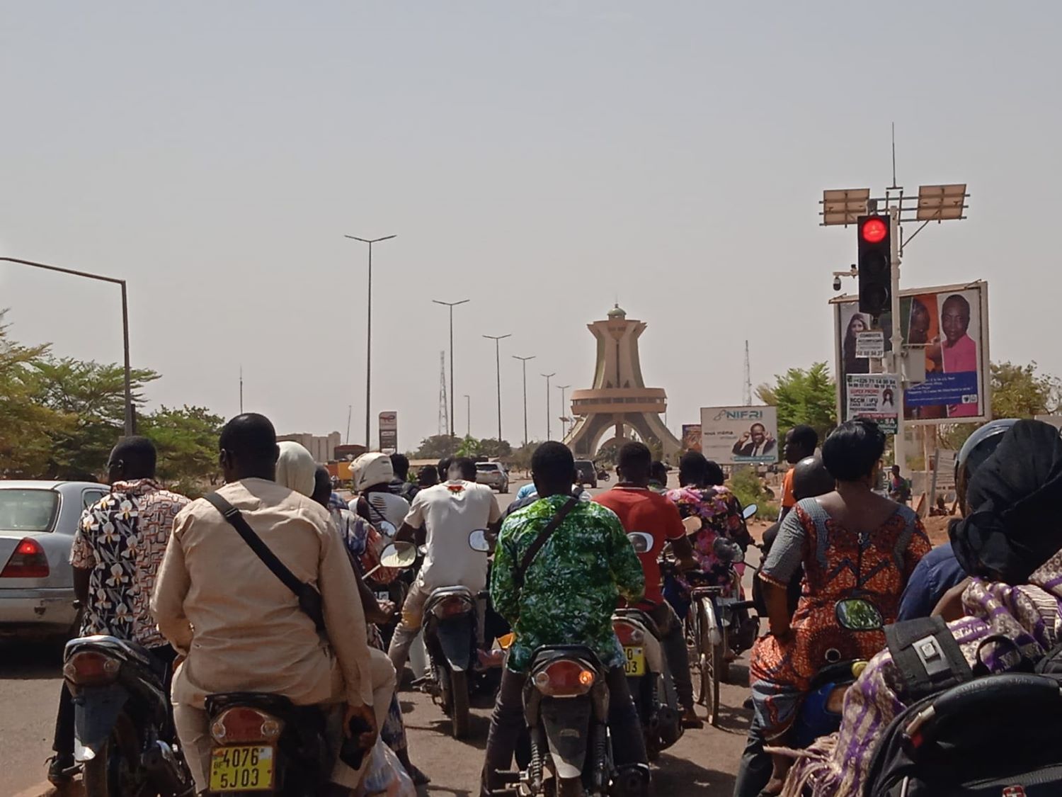 Sur la moto, en route pour l’entretien avec la coordinatrice du FIGO, Tatiana longe la grande avenue qui mène au monument des Héros nationaux que l’on peut voir au fond © Globe Reporters