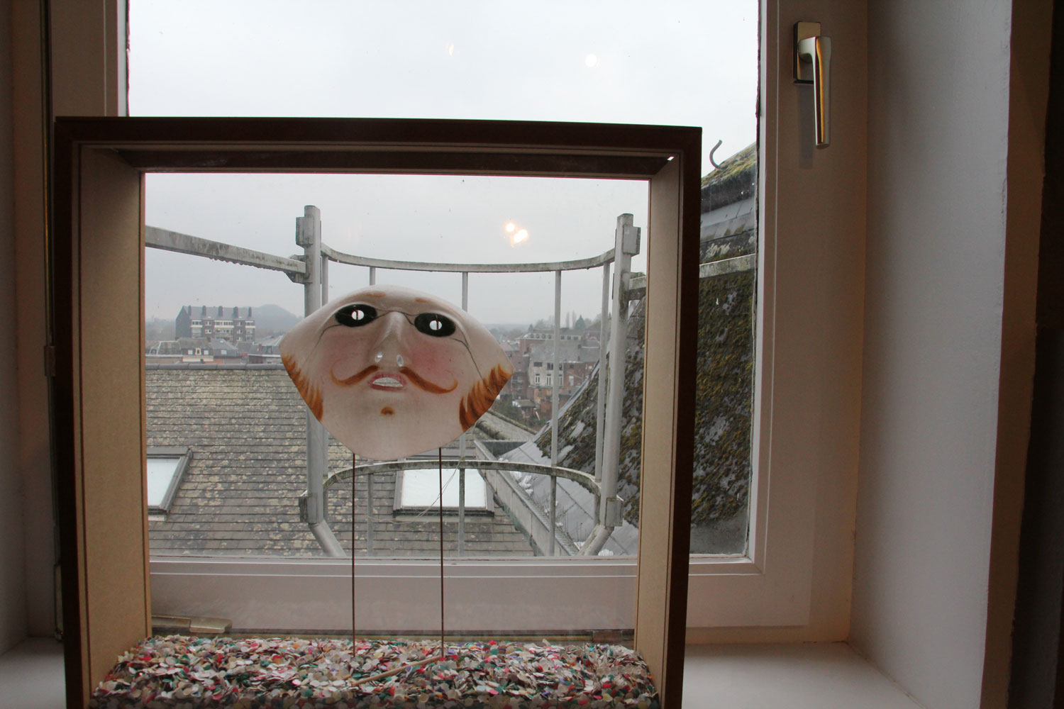 Dans le bureau de la directrice, un masque fait en paraffine et des confettis qui inondent les pavés de la ville les jours de carnaval © Globe Reporters