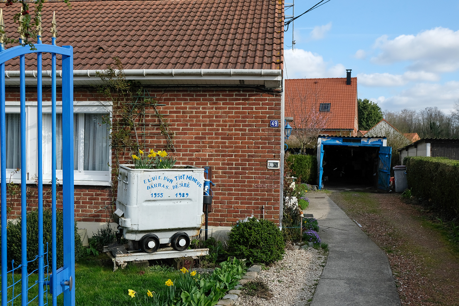 La berline à l’entrée de la maison de Désiré est sans équivoque : 