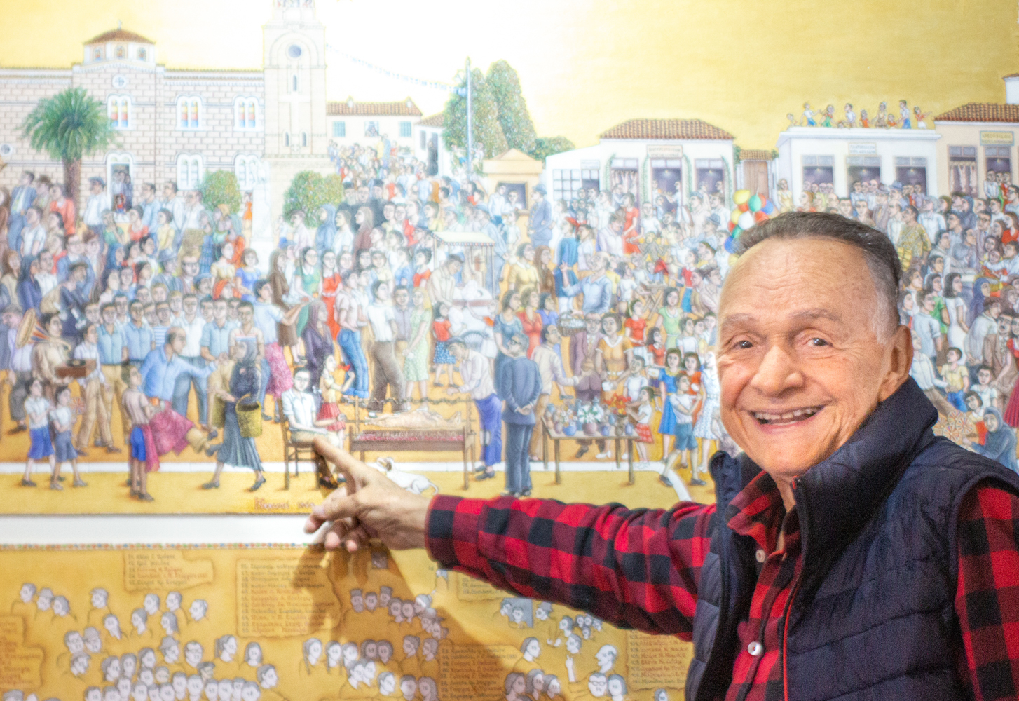 Iannis PROFIS devant son tableau d’une fête grecque traditionnelle (panigiri) © Globe Reporters 